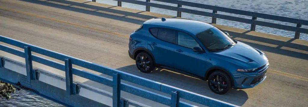 2023 Dodge Hornet driving on a bridge over water