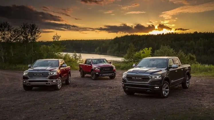Group of 2022 RAM 1500 trucks with a sunset background